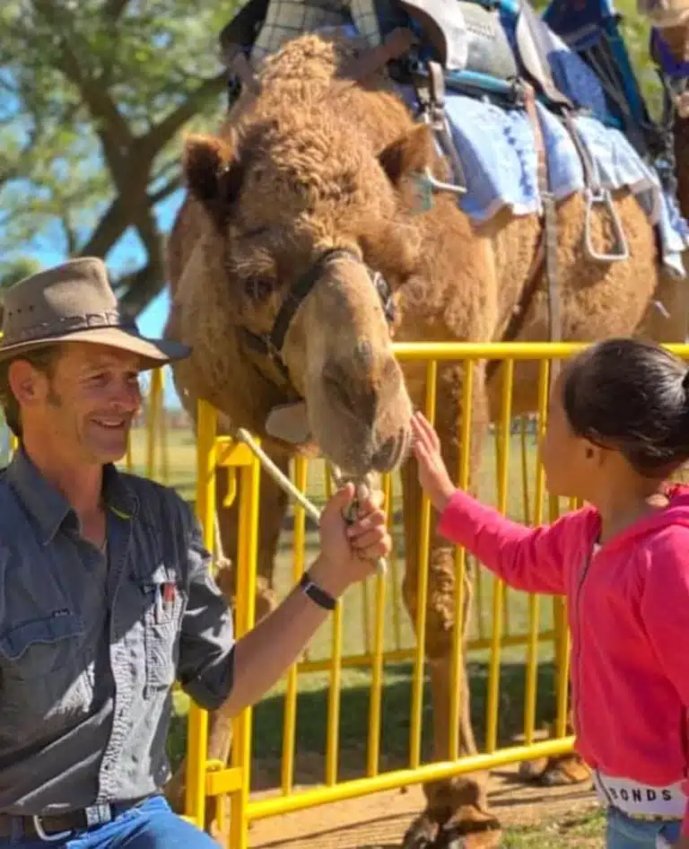 Child meeting a camel