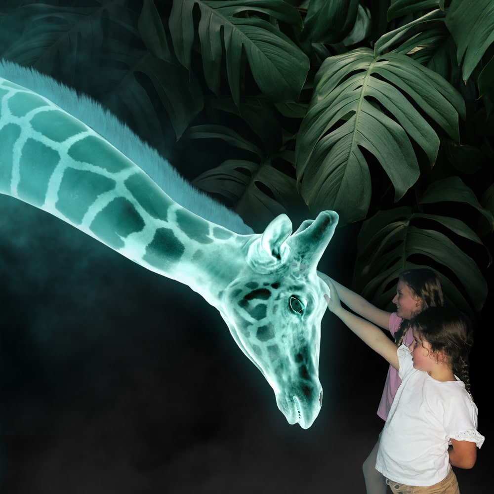 Children patting the holographic giraffe at Hologram Zoo 