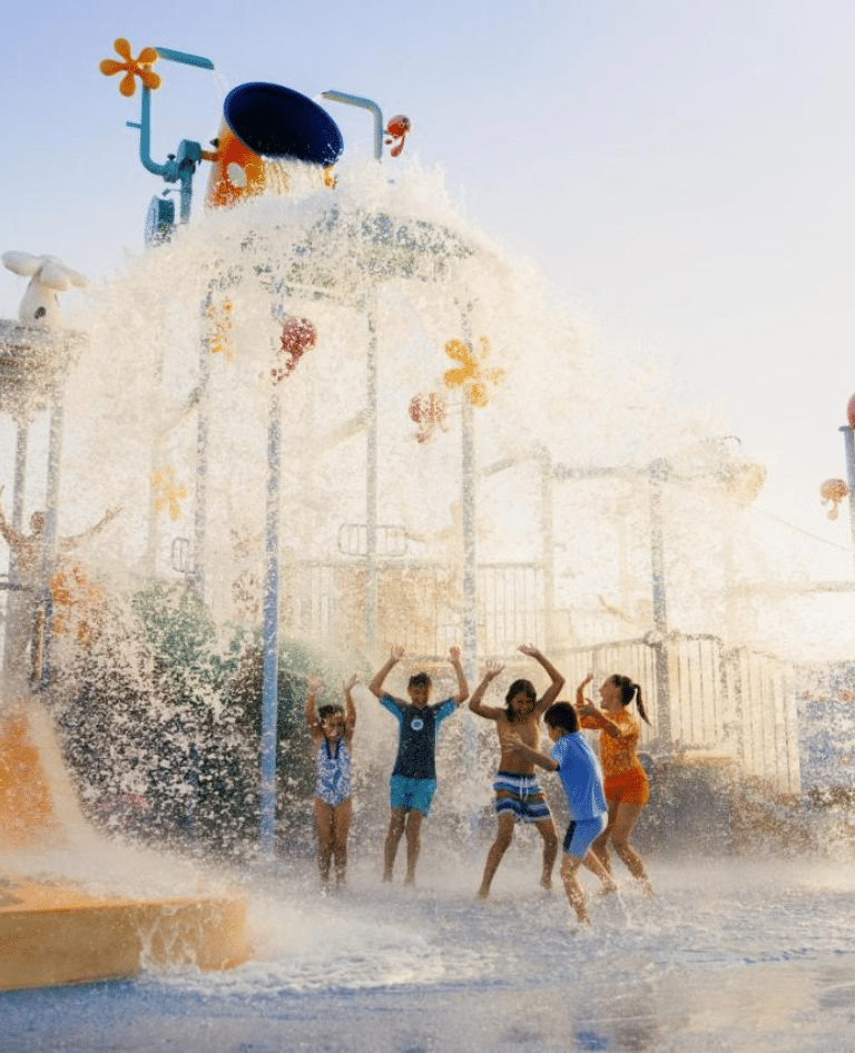 Kids being dumped by the water bucket at Sea World Resort Aqua Park