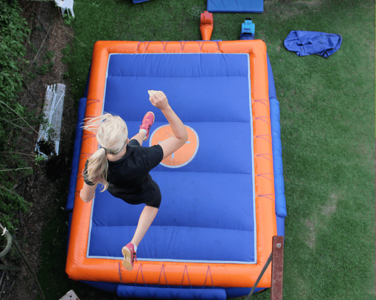 Girl jumping into giant cushion
