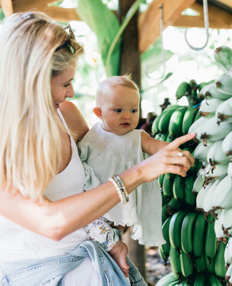 Mum and baby looking at the bananas,