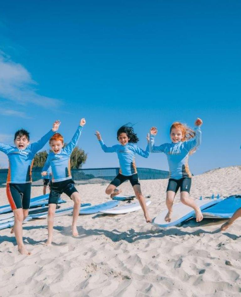 Kids jumping for joy on Gold Coast beach