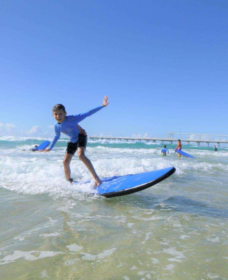 Kids learn to surf.