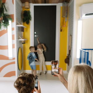 Boy and girl at the front door of the upside down house.