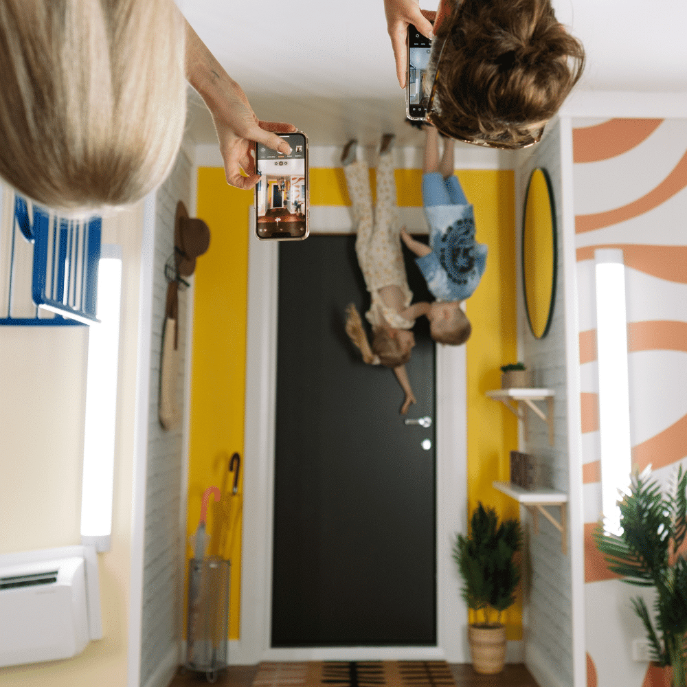 Boy and girl at the front door of the upside down house.