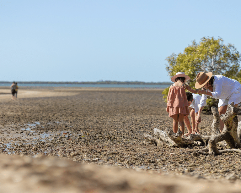 Children with mum playing on beach along King Island walk