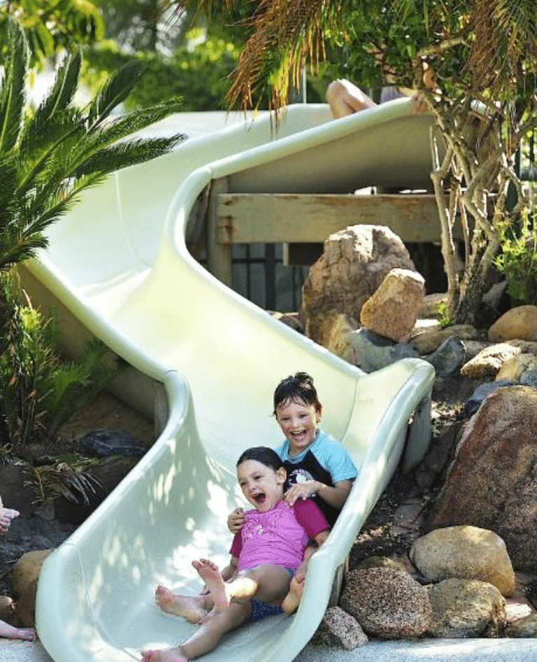 Kids having fun on the waterslide at Treasure Island Holiday Park