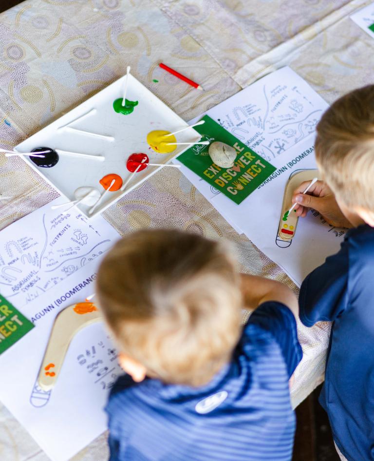 Children completing their Little Explorers activity books