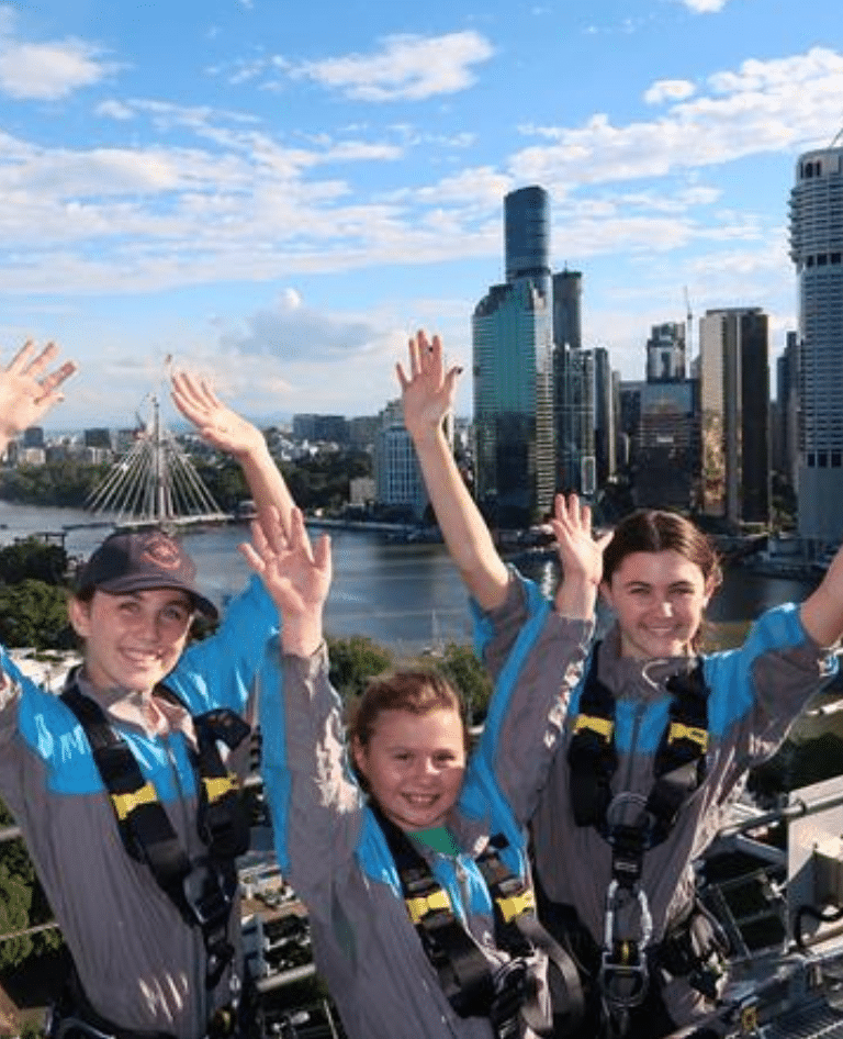 Children celebrating making it to the top of the Story Bridge