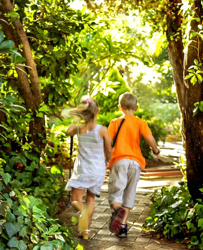 Children running in the gardens