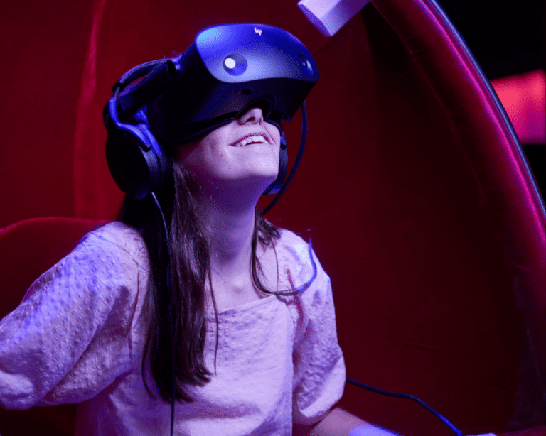 Girl in VR goggles on Voyager Theatre Experience