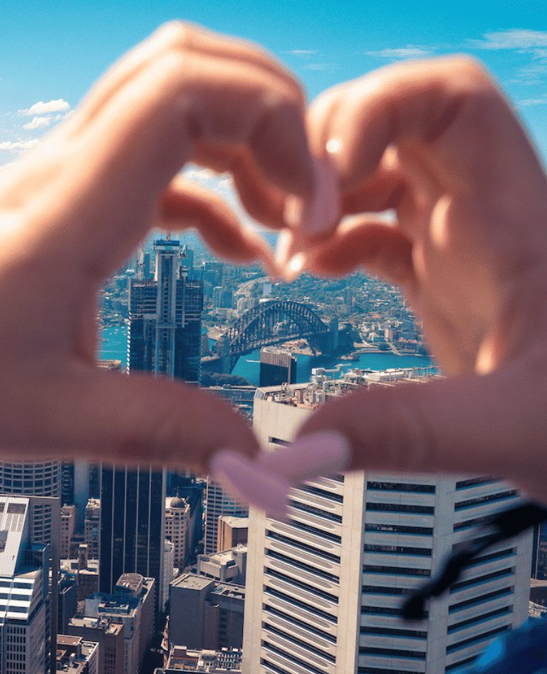 Heart hands looking at the Sydney Harbour Bridge