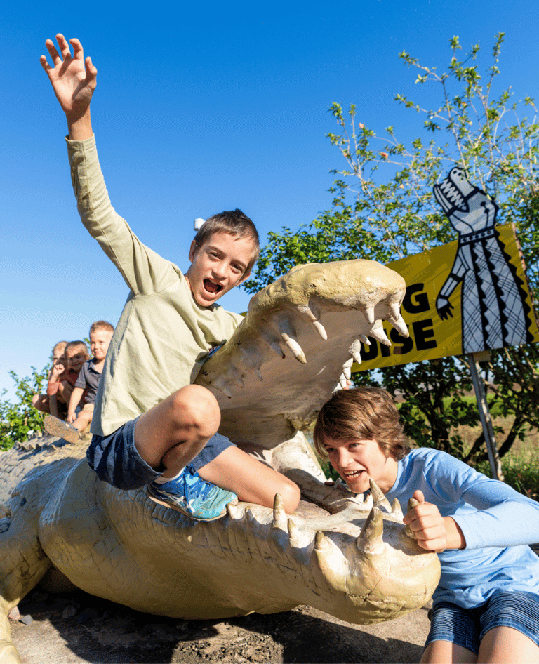 Kids on the crocodile statue