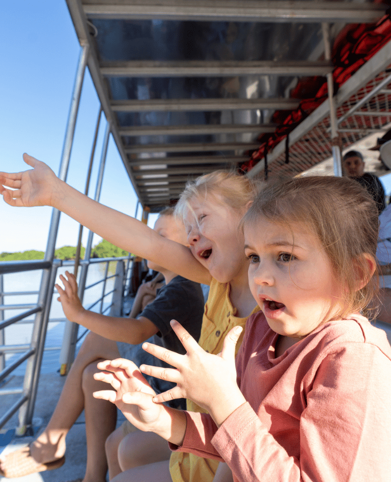 Children looking on in shock on crocodile cruise